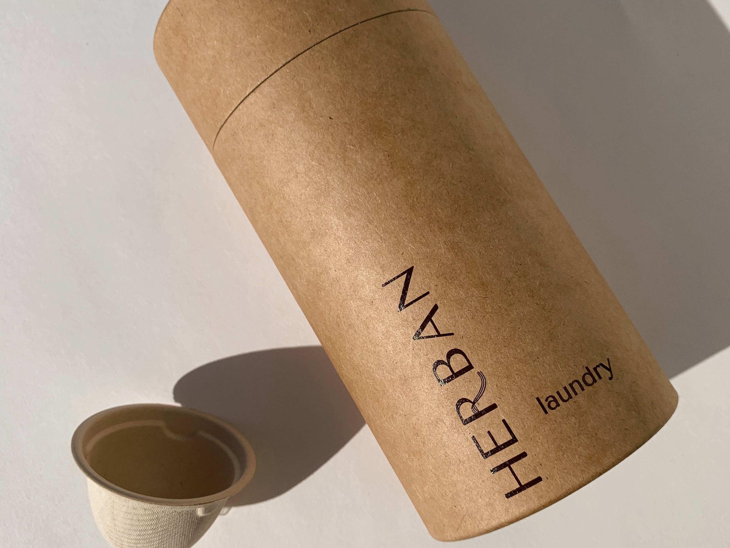 Kraft paper tube imprinted with Herban Laundry